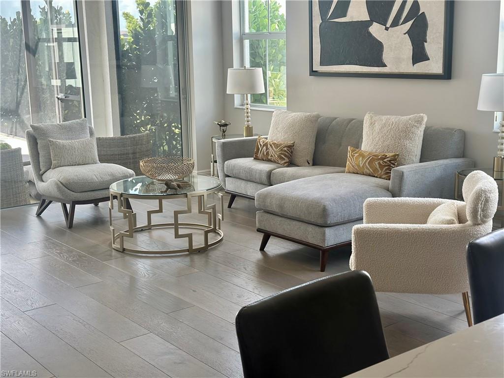 9179 Cayman Drive Naples, FL 34114 - Photo 11 of 50 a living room with furniture and a large window