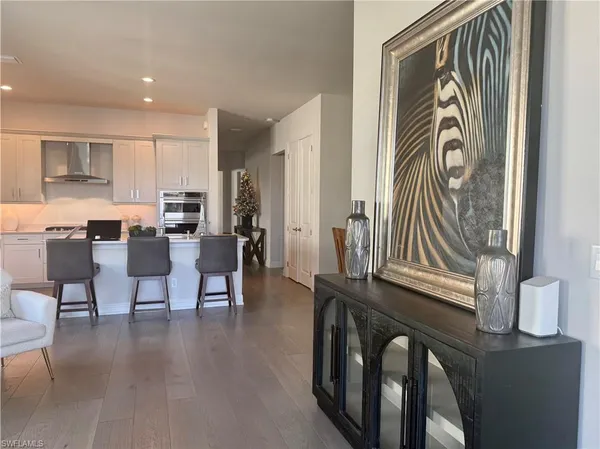 a view of a a dining room with furniture window and wooden floor