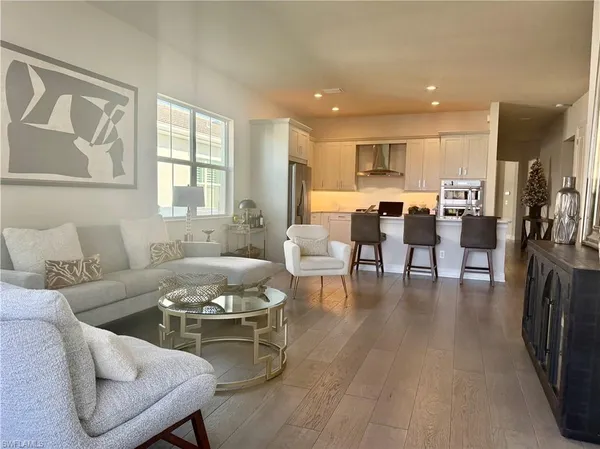 a living room with furniture and kitchen view