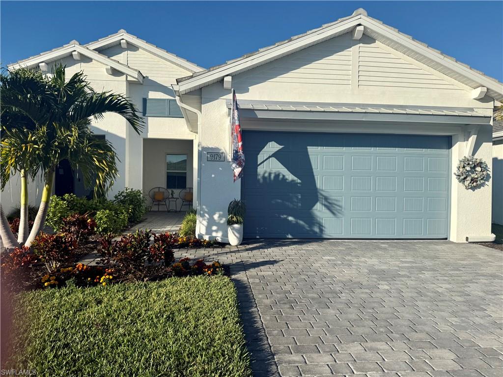 9179 Cayman Drive Naples, FL 34114 - Photo 2 of 50 a front view of a house
