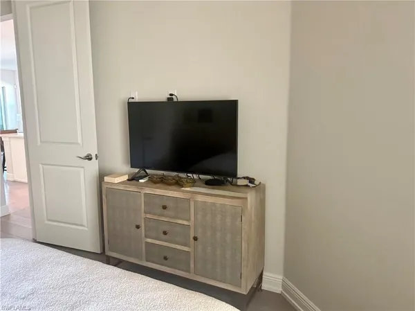 a living room with furniture and flat screen tv