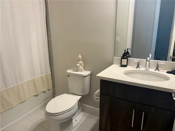 a bathroom with a sink toilet and mirror