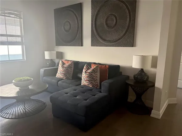 a living room with furniture and a window