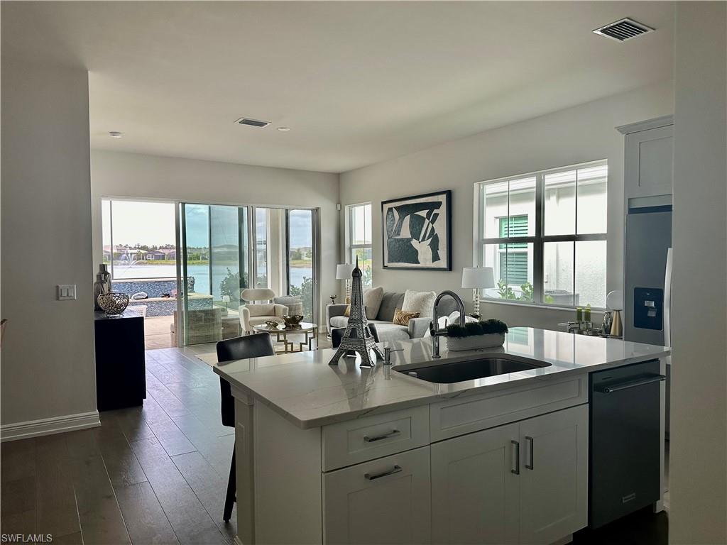 9179 Cayman Drive Naples, FL 34114 - Photo 6 of 50 a kitchen with a sink and living room