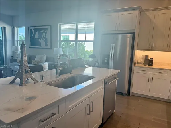 a en suite bathroom with a granite countertop sink and a mirror