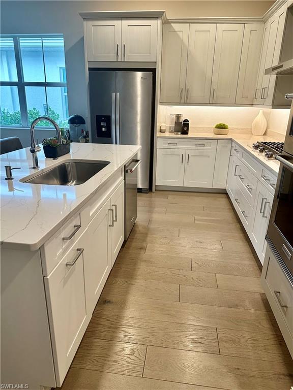 9179 Cayman Drive Naples, FL 34114 - Photo 7 of 50 a kitchen with stainless steel appliances granite countertop a sink and a refrigerator