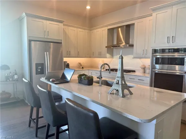 a kitchen with a sink cabinets and refrigerator