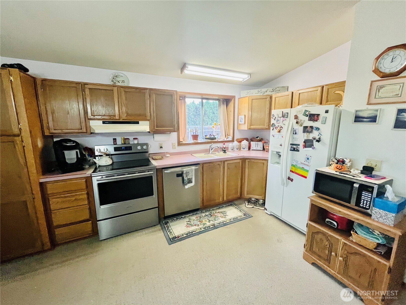 840 Northeast Karol Loop Walla Walla, WA 99362 - Photo 12 of 17 a kitchen with stainless steel appliances a stove a sink a refrigerator cabinets and a window