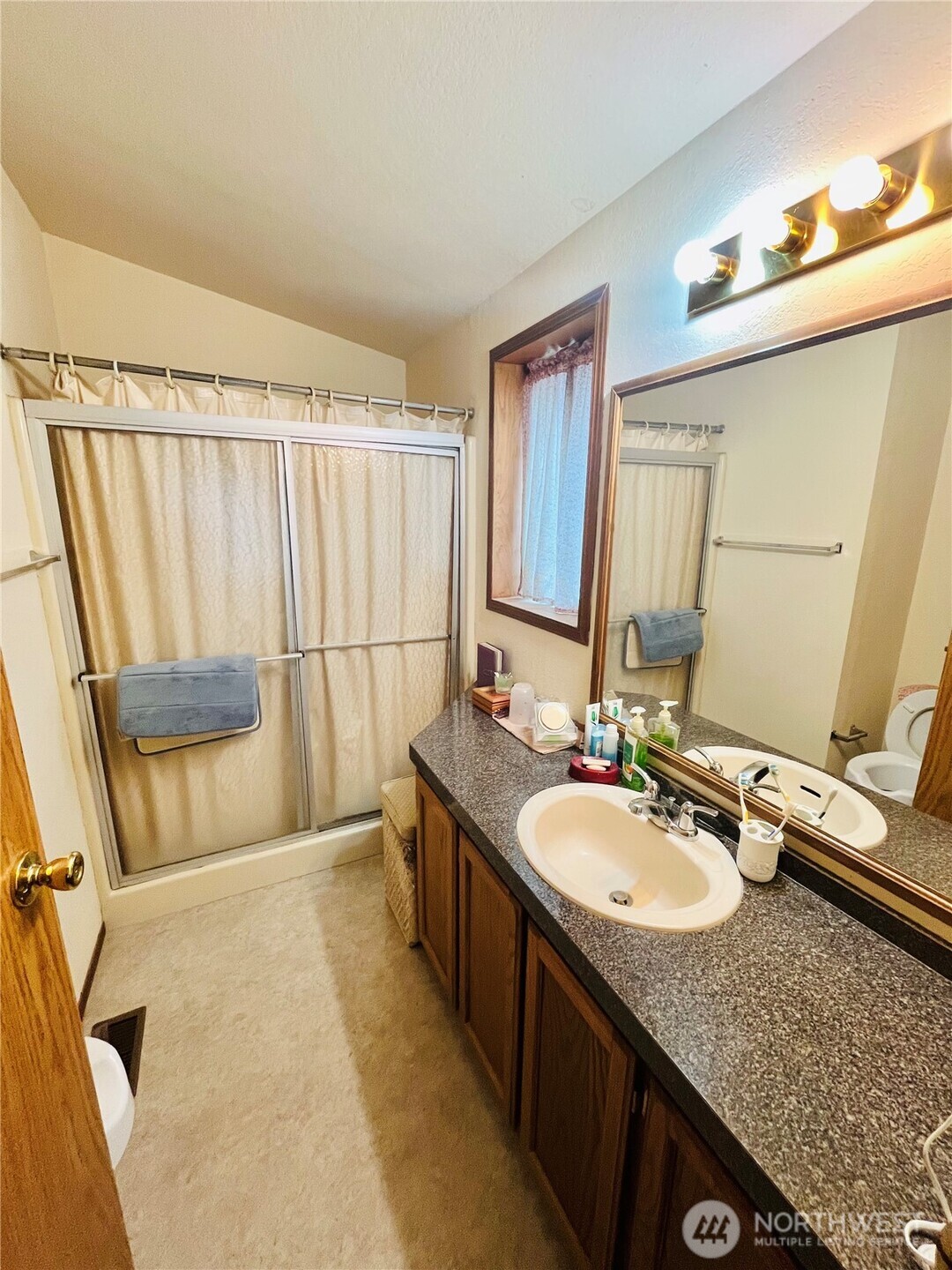 840 Northeast Karol Loop Walla Walla, WA 99362 - Photo 6 of 17 a bathroom with a granite countertop sink and a mirror