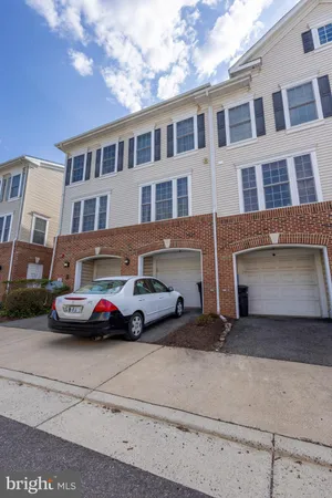 a front view of a house with parking space