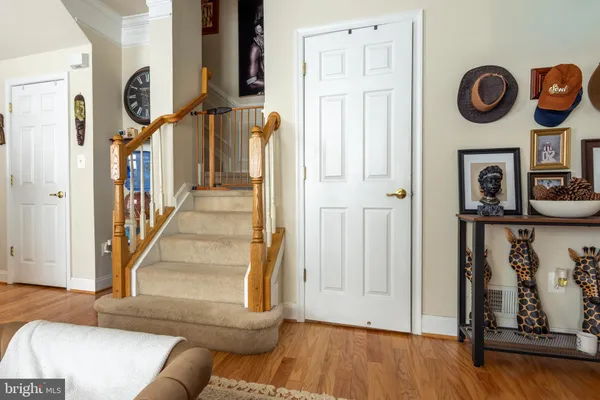 a view of a hallway with wooden floor and entryway