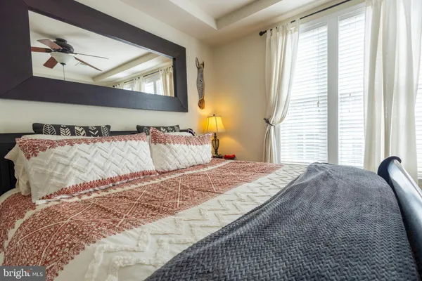 a bedroom with a bed and a painting on the wall