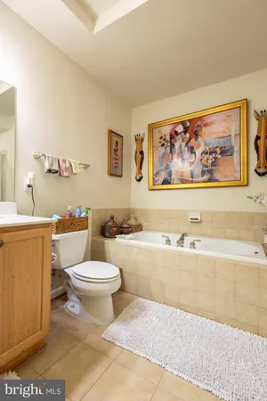 a white toilet sitting next to a bathroom sink and a bathtub