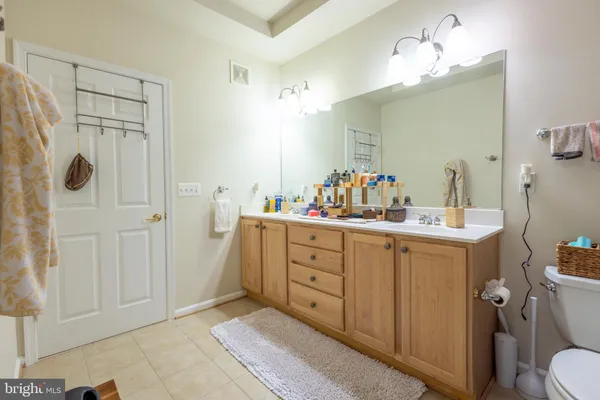 a bathroom with a sink vanity mirror and toilet