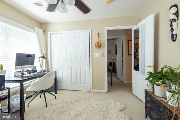 a view of a livingroom with workspace and a window