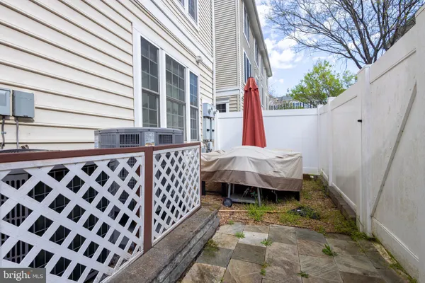 a backyard of a house with a large tree