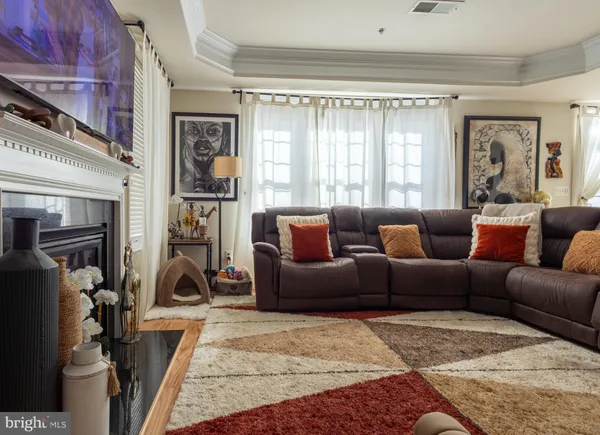 a living room with furniture a window and a fireplace