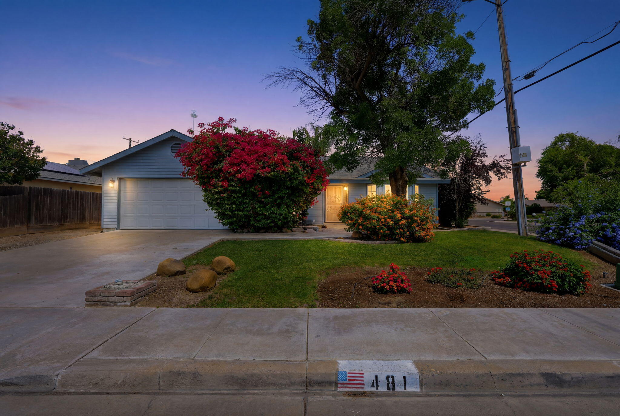 a front view of a house with a yard and a garage