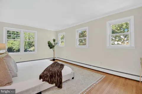 a room with a bed and wooden floor