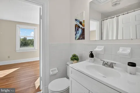 a bathroom with a sink a toilet and a mirror