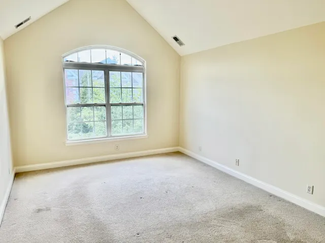 an empty room with a empty space and windows
