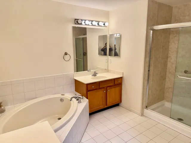 a bathroom with a tub sink and shower