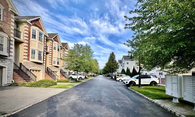 a view of a street with a cars parked in front of it