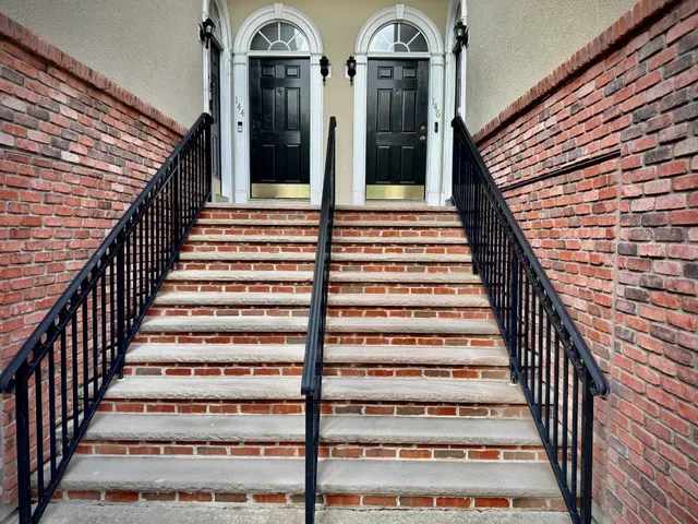a view of entryway with wooden floor and a front door