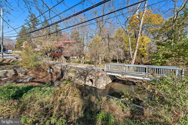 a view of a yard with wooden fence