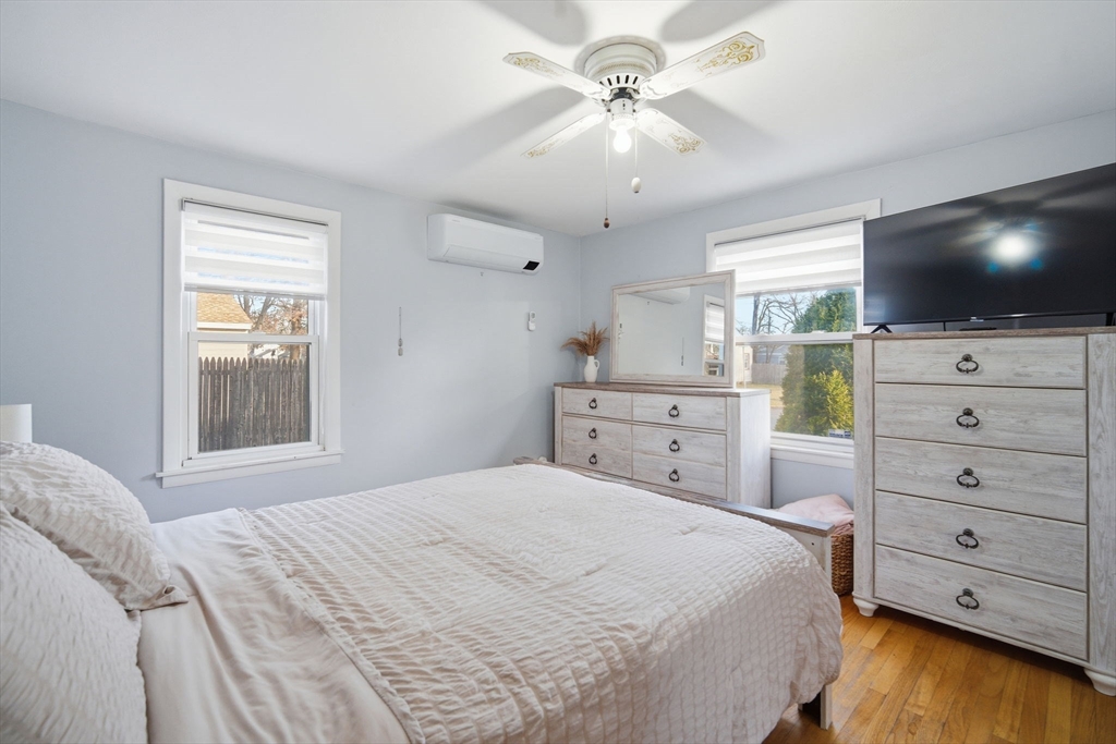 26 Cuff Avenue Springfield, MA 01104 - Photo 12 of 26 a bedroom with a large bed and a flat tv screen on dresser