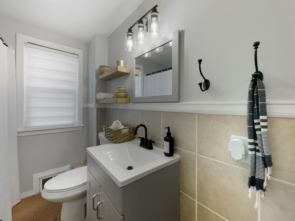 26 Cuff Avenue Springfield, MA 01104 - Photo 18 of 26 a bathroom with a sink a toilet and a mirror