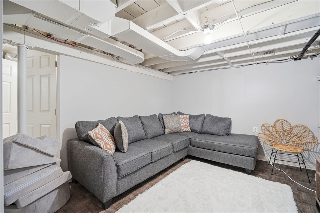 26 Cuff Avenue Springfield, MA 01104 - Photo 19 of 26 a living room with furniture and a chandelier