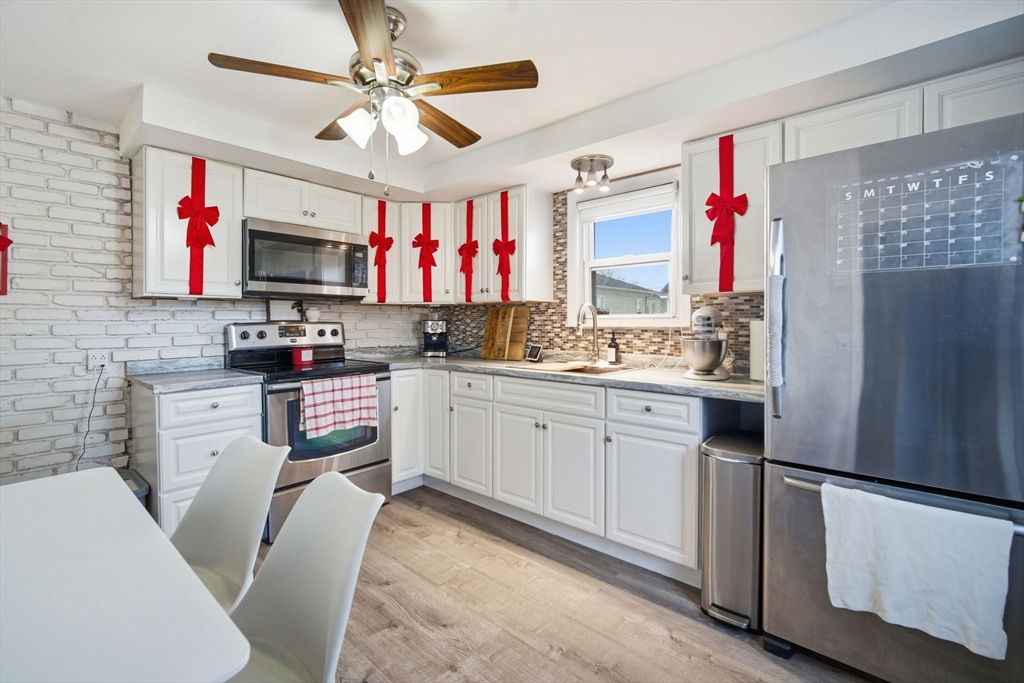 26 Cuff Avenue Springfield, MA 01104 - Photo 7 of 26 a kitchen with stainless steel appliances a refrigerator sink and microwave