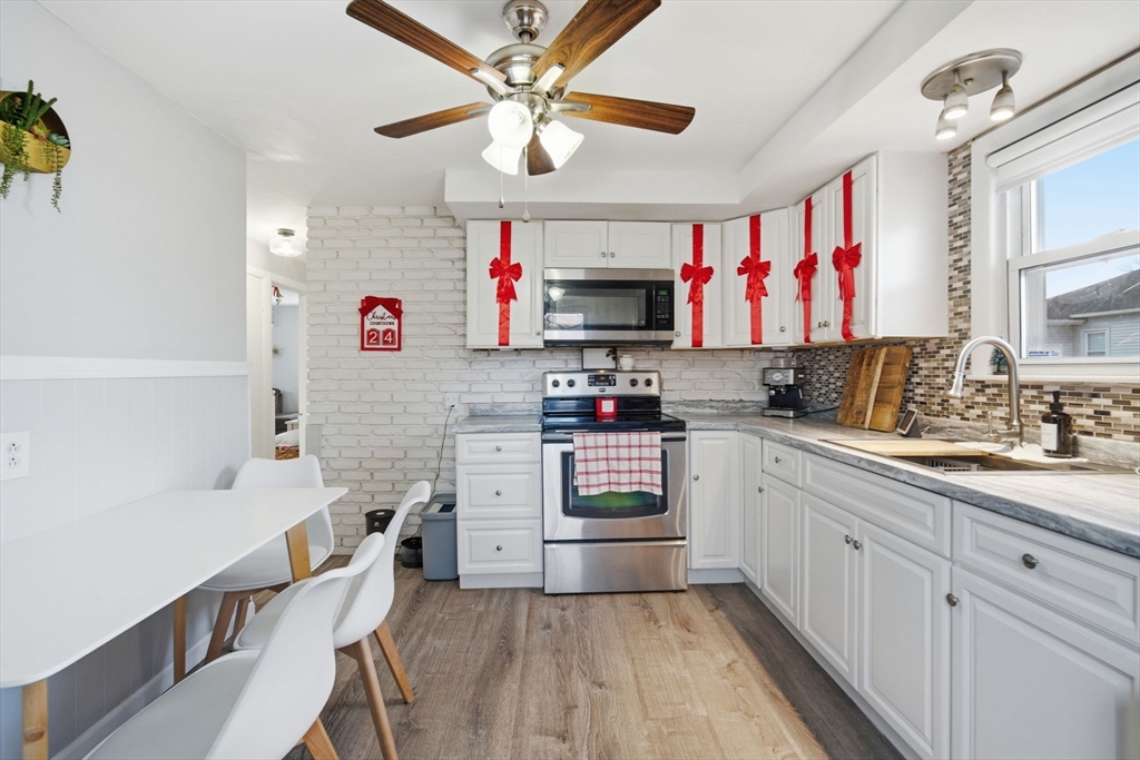 26 Cuff Avenue Springfield, MA 01104 - Photo 8 of 26 a kitchen with cabinets a sink and a stove