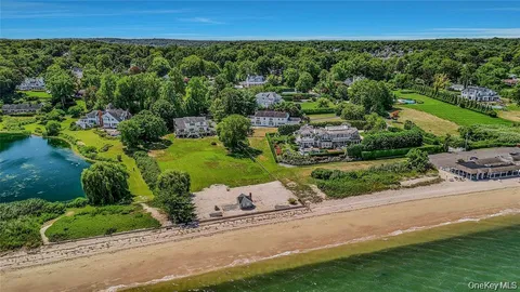 an aerial view of a house with a yard and lake view