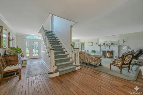 a view of entryway livingroom and hall with wooden floor