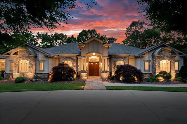 a front view of a house with a garden and yard