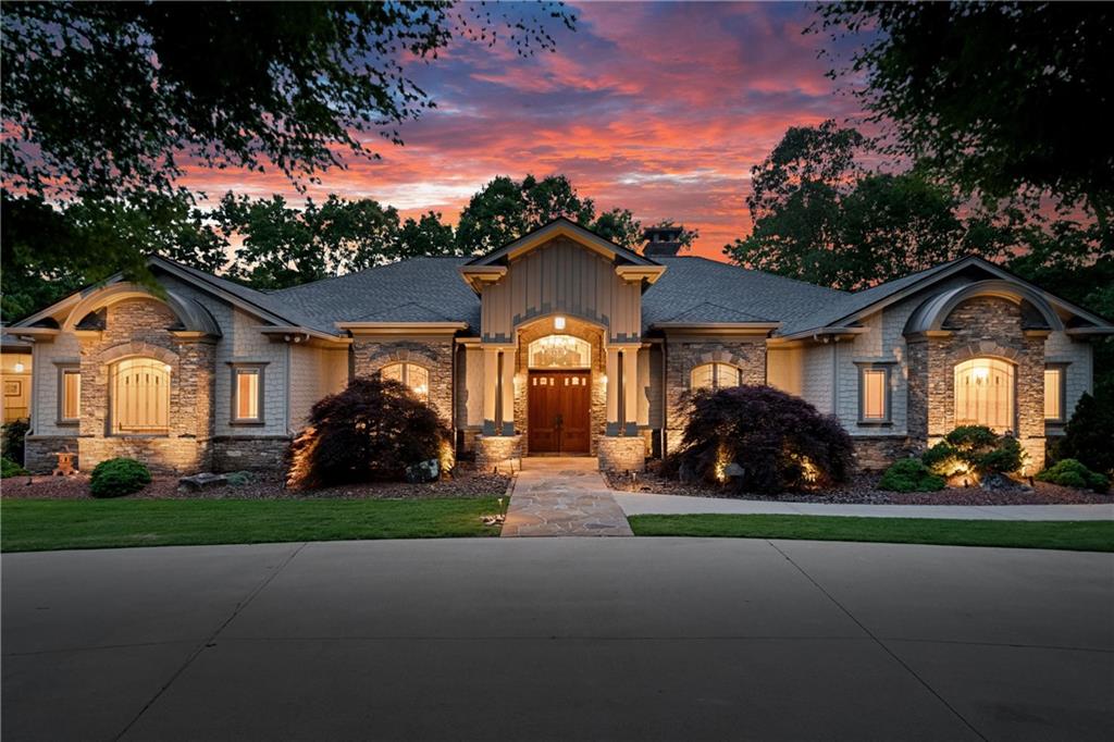 a front view of a house with a garden and yard