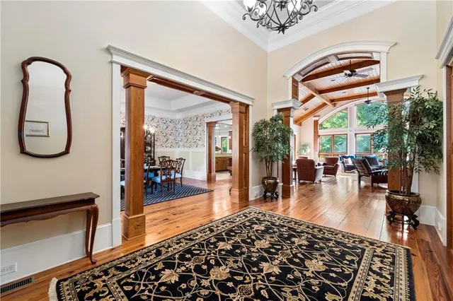 a living room with furniture and floor to ceiling windows