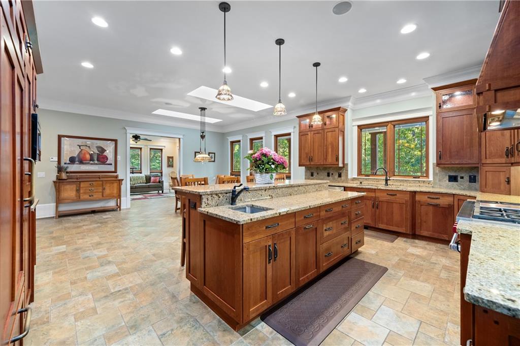 1447 Travis Smith Road Clarkesville, GA 30523 - Photo 26 of 73 a large kitchen with stainless steel appliances granite countertop a large stove a sink dishwasher and a living room view