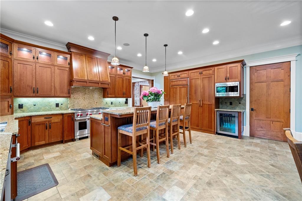 1447 Travis Smith Road Clarkesville, GA 30523 - Photo 28 of 73 a kitchen with stainless steel appliances kitchen island granite countertop a stove refrigerator and cabinets