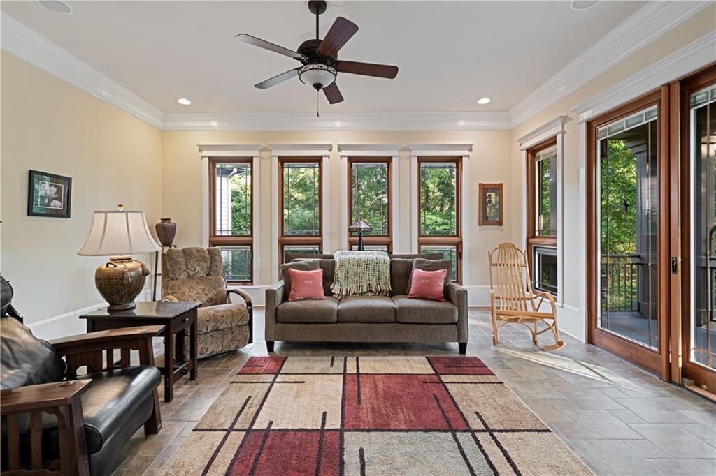 1447 Travis Smith Road Clarkesville, GA 30523 - Photo 30 of 73 a living room with furniture and floor to ceiling windows