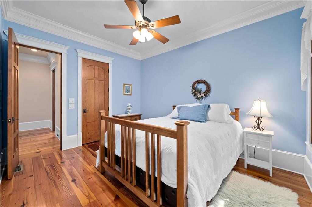 1447 Travis Smith Road Clarkesville, GA 30523 - Photo 43 of 73 a bedroom with a bed and a chandelier