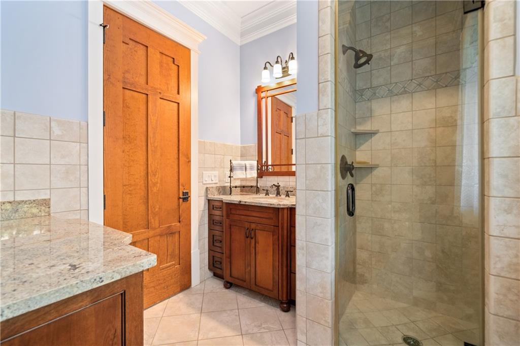 1447 Travis Smith Road Clarkesville, GA 30523 - Photo 44 of 73 a bathroom with a granite countertop sink and a mirror