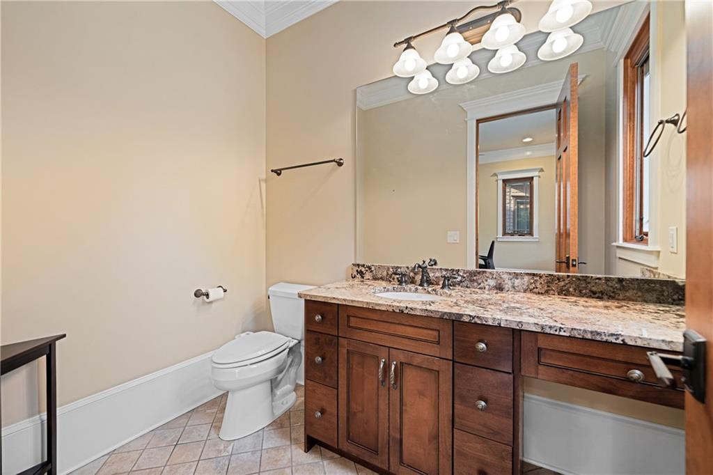 1447 Travis Smith Road Clarkesville, GA 30523 - Photo 46 of 73 a bathroom with a granite countertop sink a toilet and a mirror