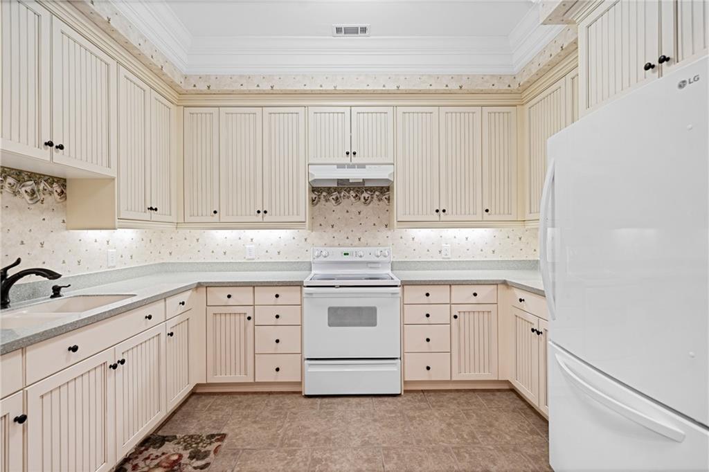 1447 Travis Smith Road Clarkesville, GA 30523 - Photo 52 of 73 a kitchen with white cabinets and white appliances