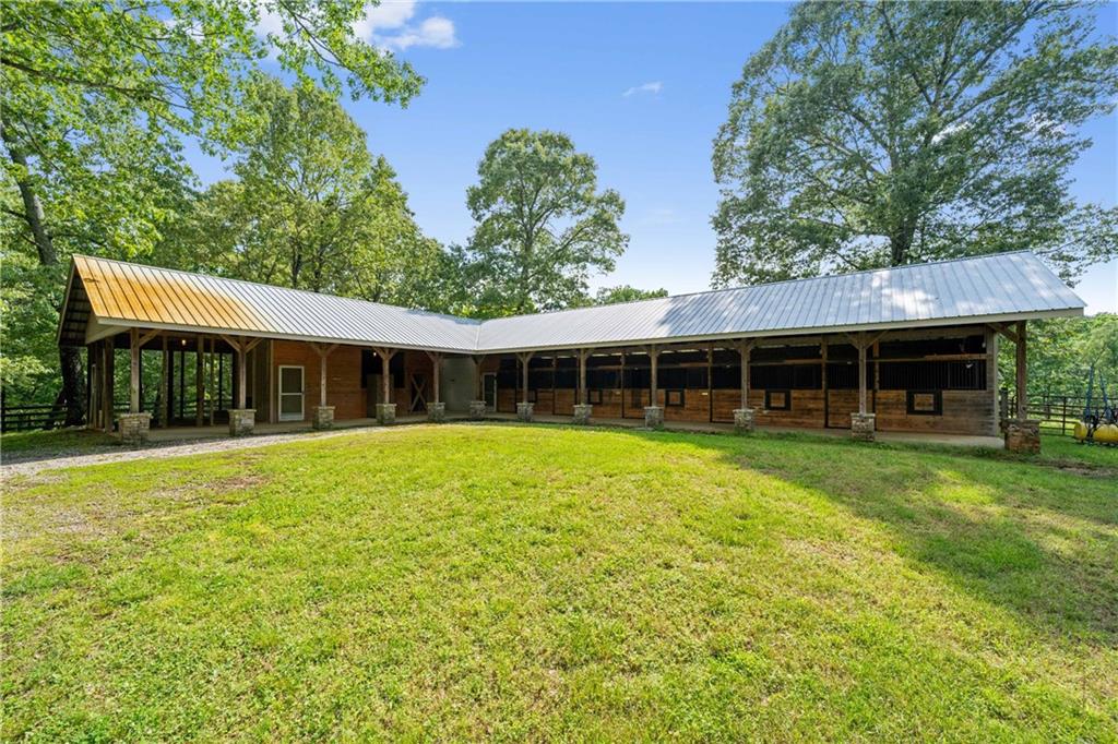 1447 Travis Smith Road Clarkesville, GA 30523 - Photo 7 of 73 a front view of a house with a garden