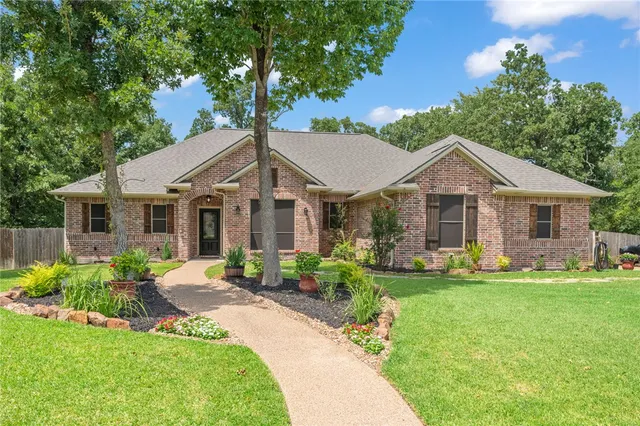 a front view of a house with a yard porch and outdoor seating