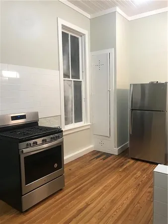 a kitchen with a stove and a refrigerator