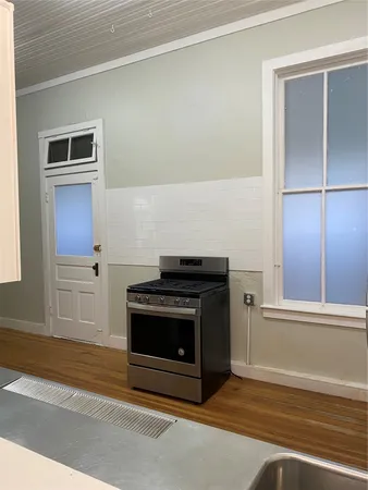 a stove top oven sitting inside of a kitchen